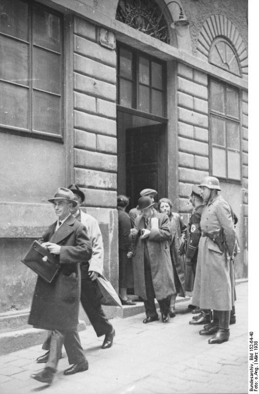 SS-Razzia at the Israelitische Kultusgemeinde Wien, March 1938; Bundesarchiv, Bild 152-64-40 / CC-BY-SA 3.0 [CC BY-SA 3.0 de (https://creativecommons.org/licenses/by-sa/3.0/de/deed.en)], via Wikimedia Commons